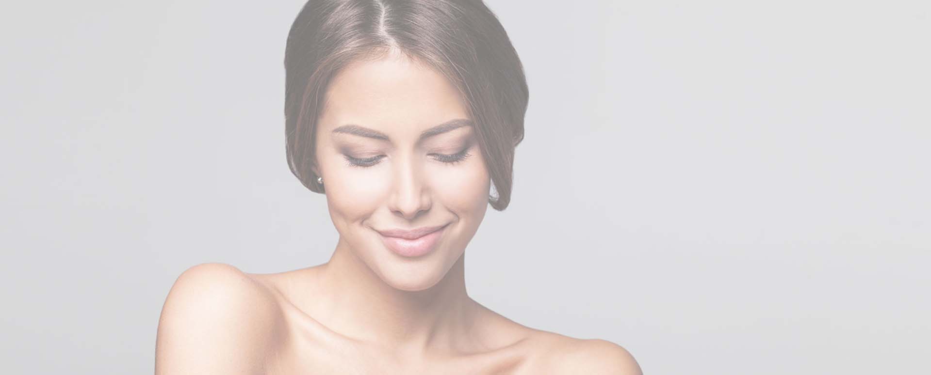 Headshot of beautiful model looking down with bare shoulders