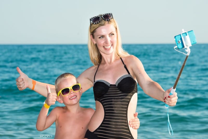 Mother and son taking a selfie at the beach